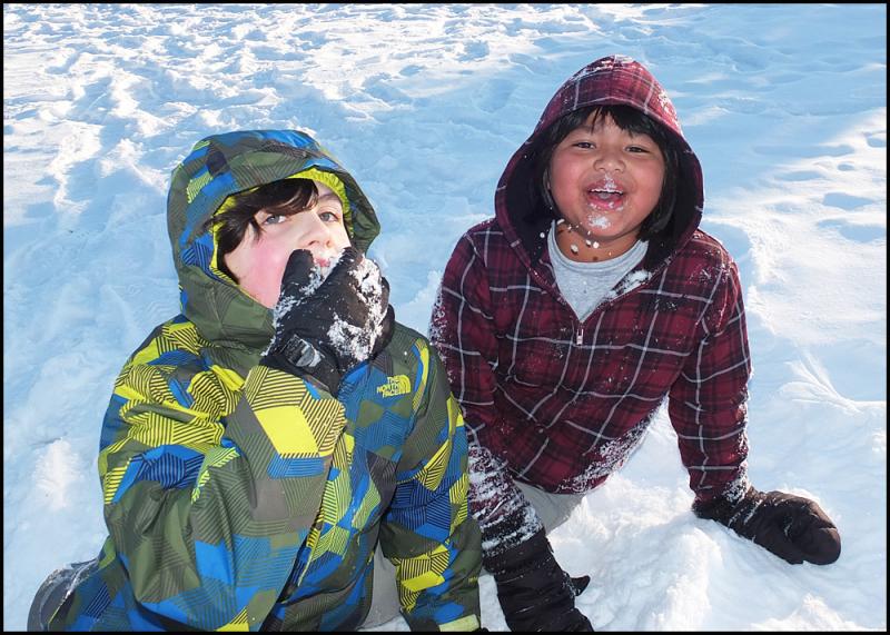 Sam Skovran and A.J Defazio take a snow break at Library Hill on Saturday.