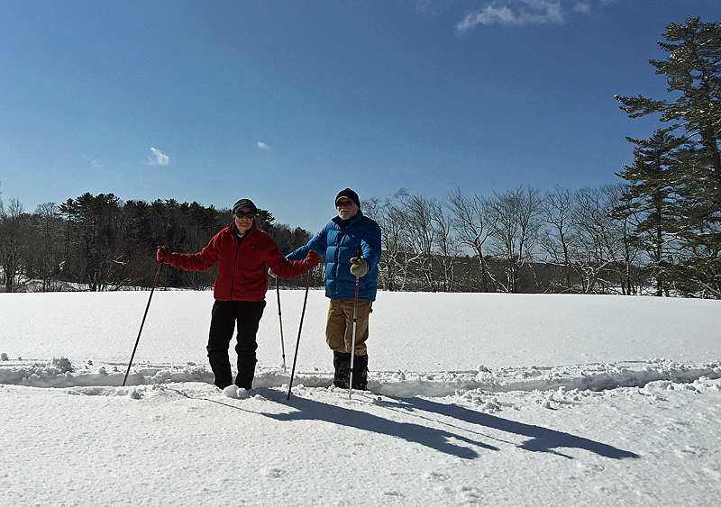 A pair of snowshoers, Jack and Barb Moore, make their way back across the Aldermere Farm cow pasture, having trekked the Lily Pond trail. (Photo by Holly S. Edwards)