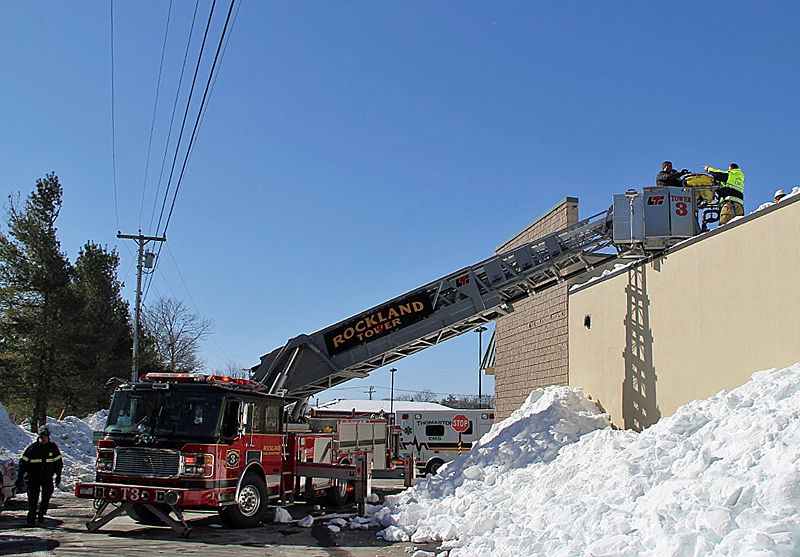 Rockland Fire and EMS personnel work to bring an injured contractor off the Hannaford supermarket roof Saturday morning. (Courtesy Rockland Fire Dept./by Alan Athearn)