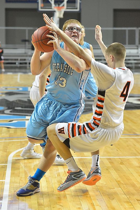 Oceanside’s Nick Mazurek drives hard down the lane during Saturday’s game. (Photo by Ron Hawkes)