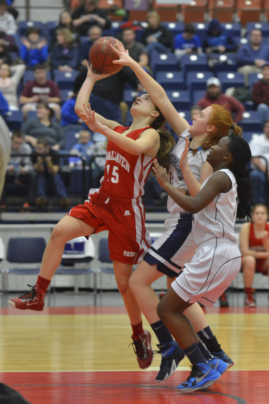 Vinalhaven’s Deja Doughty, left, goes up strong for the basket and the foul. (Photo by Ron Hawkes)