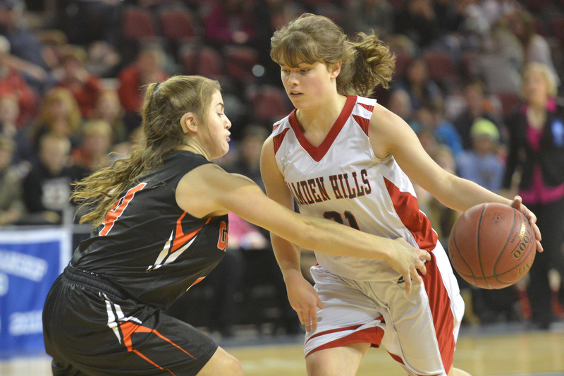 Camden Hills' Maddie Bowman drives past a Gardiner defender during Wednesday’s semifinal game in Bangor at the Cross Center. Gardiner won the game 53-42. (Photo by Ron Hawkes)