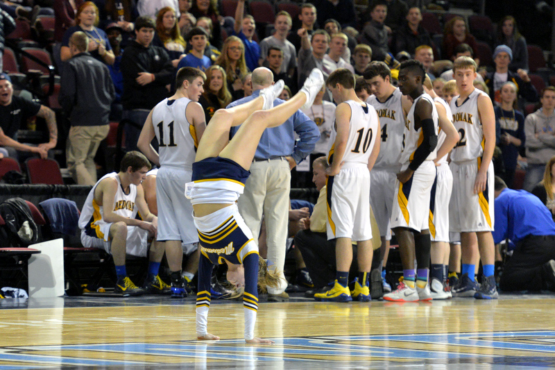 During a timeout Medomak’s Ashlee Wilson captivated the audience and a couple of the players with her tumbling exhibition. (Photo by Ron Hawkes)