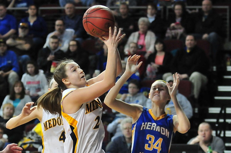 Medomak Valley’s Hannah Heald (24) pulls a rebound away from Hermon's Emi Higgins in the Feb 13 game. (Courtesy of Skip Hawkes/mainesportsreport.com)