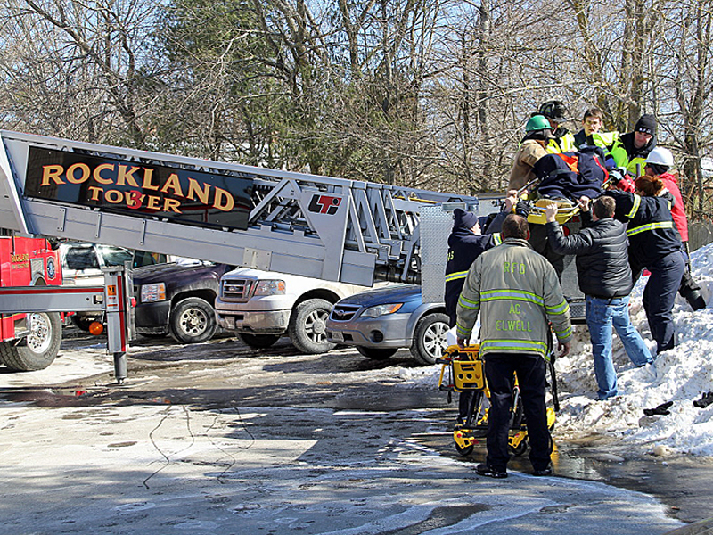 Rockland Fire and EMS personnel work to finish bringing an injured contractor off the Hannaford supermarket roof Saturday morning. (Courtesy Rockland Fire Dept./by Alan Athearn)