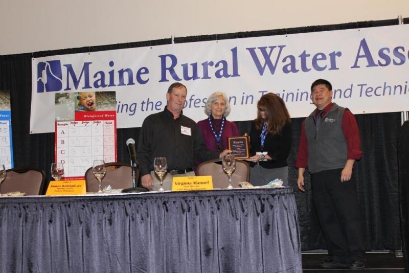 Seen receiving the award from left to right are Keith Pooler, superintendent; Cindy Clements, administrative assistant; and Tammy Morse, office manager of the Belfast Water District; and Alex Wong of Maine Rural Water presenting the award.