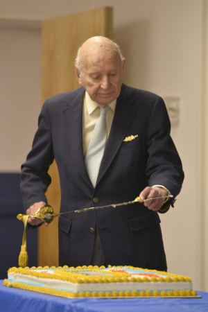 Linwood ‘Tick’ Thumm samples the cake at his 100-year birthday party March 26, 2015, at the Portsmouth Federal Building in Portsmouth, Va. Thumm was the commanding officer of an 83-foot Coast Guard cutter during World War II. (U.S. Coast Guard photo by Petty Officer 3rd Class David Weydert)