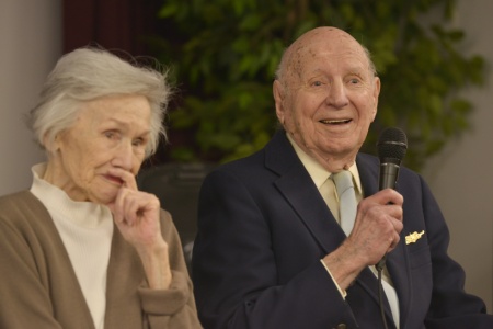 Linwood ‘Tick’ Thumm tells a joke to audience members at his 100-year birthday celebration alongside his wife Jane Thumm, March 26, 2015, at the Portsmouth Federal Building in Portsmouth, Va. Thumm was the commanding officer of an 83-foot Coast Guard cutter during World War II. (U.S. Coast Guard photo by Petty Officer 3rd Class David Weydert)