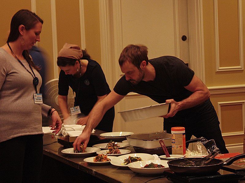 Plating up for the audience. Six lucky raffle ticket winners got to sample each chef’s dish. (Photo by Kay Stephens)