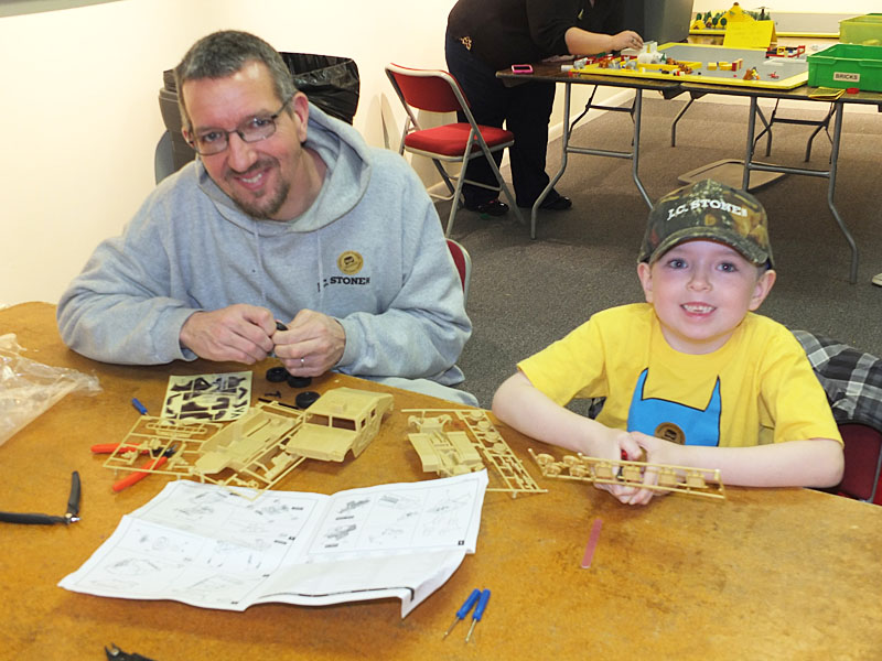 Jason & Lucas Baker, 6, of Washington, take advantage of the free workshop to build a model.