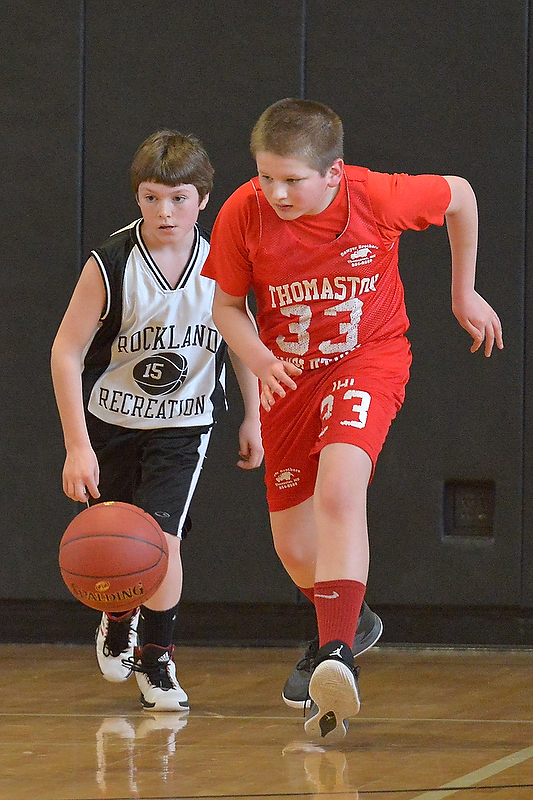 Thomaston’s Christian Weed, right, is out in front of Rockland’s Hunter Norton for a loose ball. (Photo by Ron Hawkes)