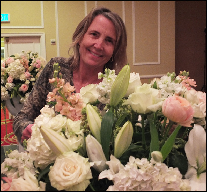 Anna Remsen adds some finishing touches to a flower arrangement for a wedding at the Samoset Resort.