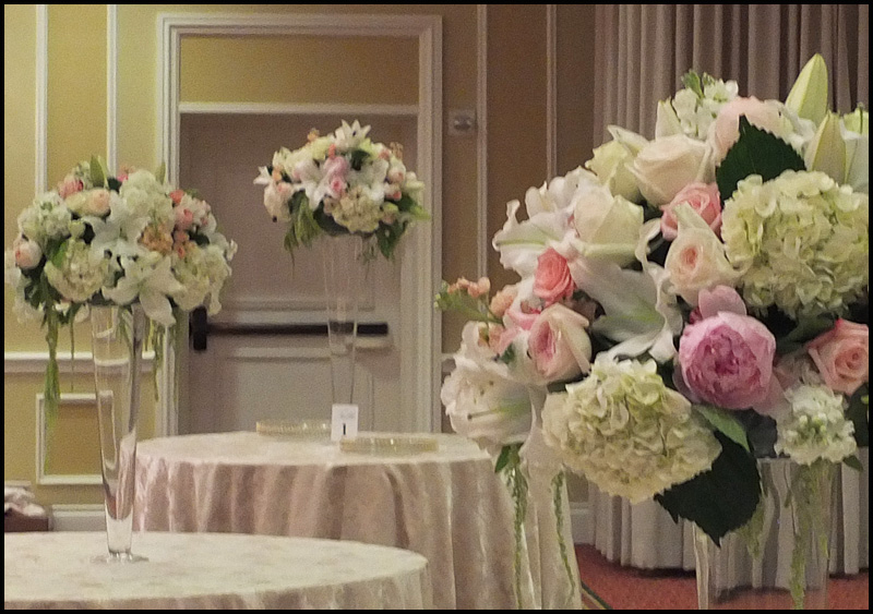 A wedding reception carries a beautiful arrangement on every table.