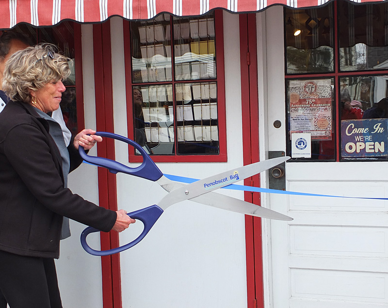 Meg Quijano cuts the ribbon to open the store for its 75th year.