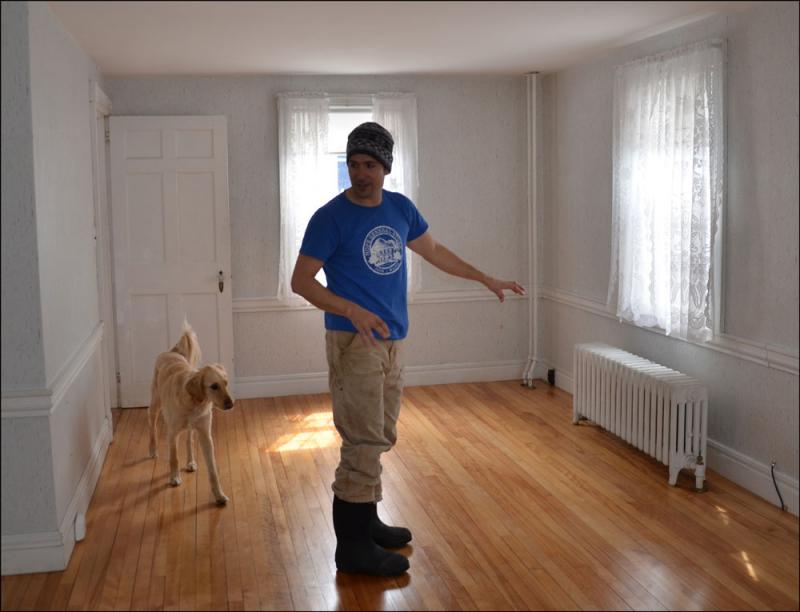 Andrew Stewart and Ollie, in the space that will host dining tables in the new Drouthy Bear. (Photo by Lynda Clancy)