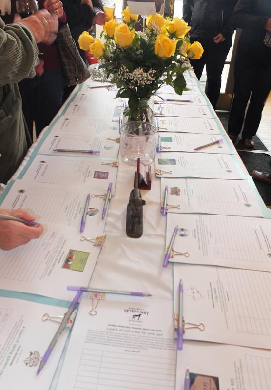 A table of silent auction items - even the flowers were raffled off.