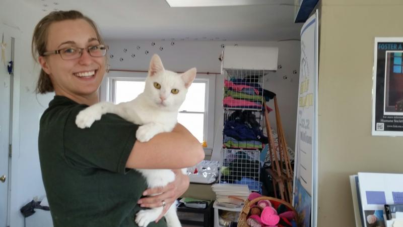 Grace McMullan, Community Events coordinator, and Triscuit, ‘office assistant’ at the shelter. Triscuit is available for adoption. (Photo by Sarah Shepherd)