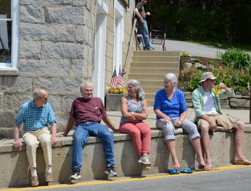 At the former Rockport Corner Shop, now home to Ralston Gallery, the public gathers for the parade. (Photo by Lynda Clancy)