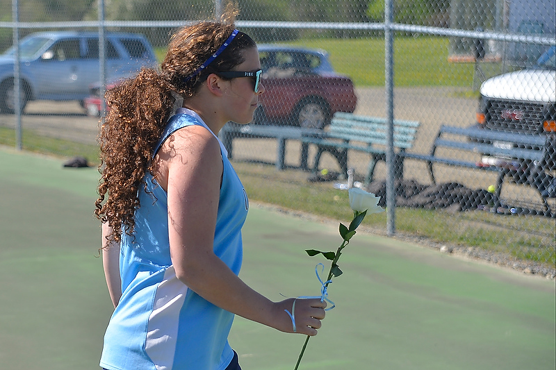 Oceanside senior Kingsley Holmes takes a flower to her dad as the team recognized the seniors for all their efforts. (Photo by Ron Hawkes)