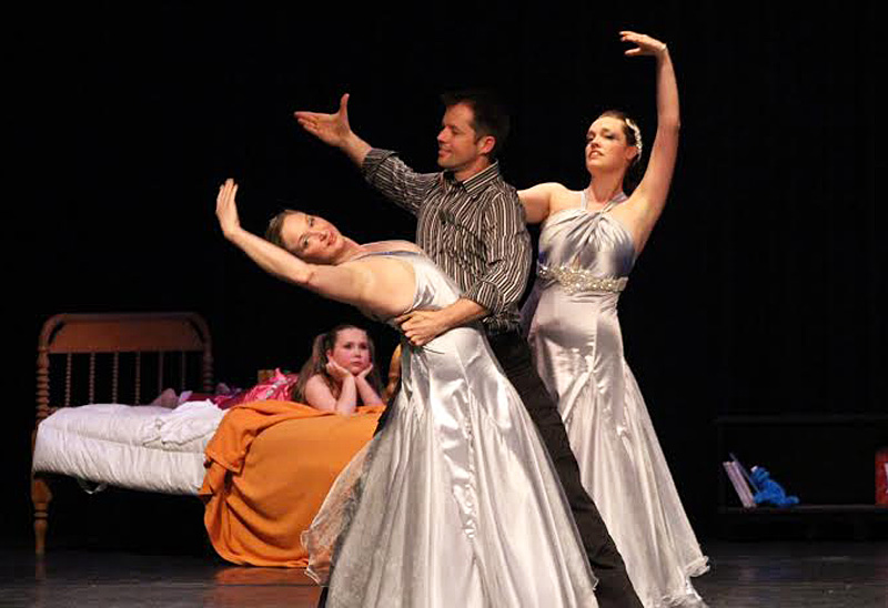 Christian Clayton (center) featured as Mr. Sandman dances with RDC director Kari Cameron (left) and assistant director Sally Leighton as the Sleeper, Kelsey Guinn looks on from her bed. (Photo by Ellie Curtis)