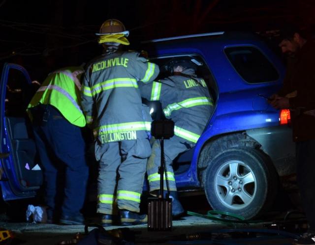 Firefighters work to free Priscilla Jones of Lincolnville from her car after it collided with another car on Route 52 on March 31. She did not sustain life-threatening injuries, but continues to recover nearly two months later. (Photo by Lynda Clancy)