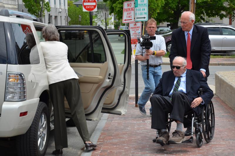 Rusty Brace is assisted by his wife, Becky, and his attorney, Peter DeTroy, into his Mercury Mountaineer Friday afternoon. (Photo by Lynda Clancy)