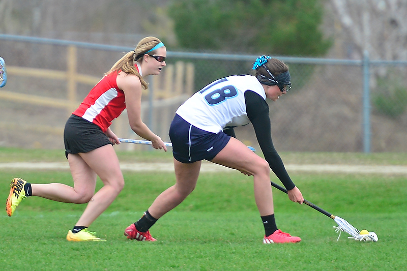 Oceanside’s Alexis Pine, right, gets to a ground ball ahead of Camden Hills Macy Buck. (Photo by Ron Hawkes)