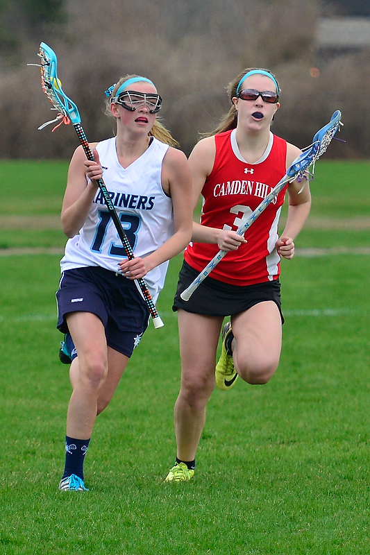 Oceanside’s Jillian Brooks, left, races up the field ahead of Camden Hills Macy Buck. (Photo by Ron Hawkes)