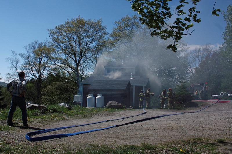 A fire at 40 John St. in Camden Thursday afternoon caused damage to an exterior wall and inside in the kitchen, both at the back of the home that sits close to the road. (Photo by Holly S. Edwards)