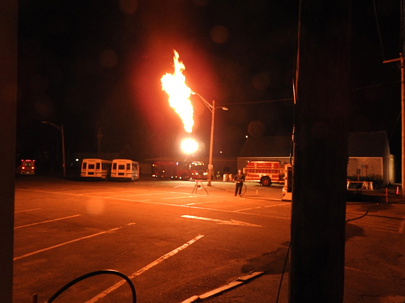 Rockland firefighters had to use a combination of water fog streams and ‘flaring,’ shown here, to disperse the propane vapors and reduce pressure to make it safe to drain the remaining liquid fuel and make repairs to the leak. (Courtesy Rockland Fire Department)