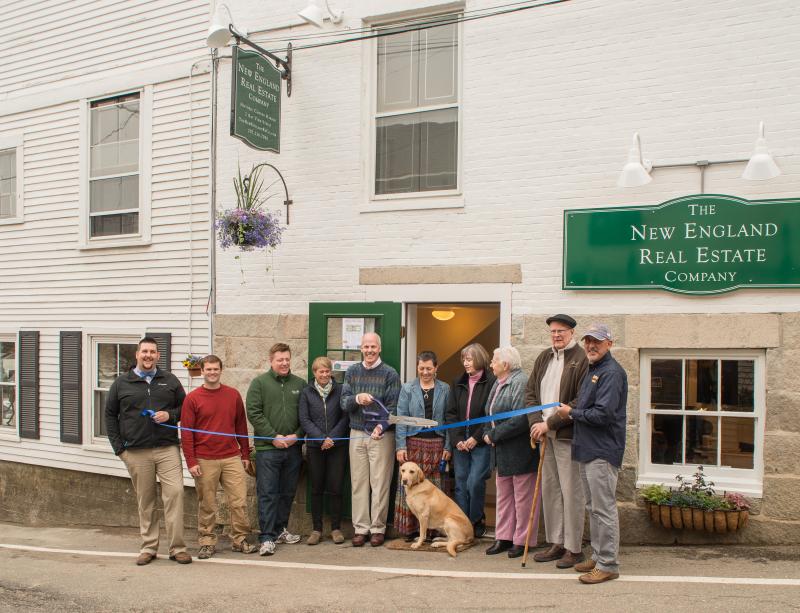 Celebrating New England Real Estate's new Bay View Street office in Camden are, from left: Erick Anderson, Camden Downtown Business Group President; Tyler Smith, Bay View Management; Dan Bookham, Allen Insurance; Karen Brace, Penobscot Regional Chamber of Commerce; A. Flint Decker, President & Founder of The New England Real Estate Co.; Gail Marie Decker, canine Annie Decker; Patricia Finnigan, Camden Town Manager; Naomi M. Decker, Charles M. Decker, David Robichaud.