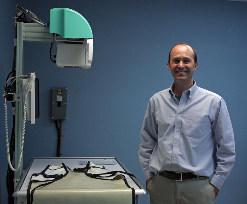 Dr. Bjorn Lee, veterinarian and owner of PenBay Veterinary Associates in Rockport, stands next to a new piece of X-ray equipment at the new Midcoast Animal Emergency Clinic on Route 90 in Warren. (Photo by Holly S. Edwards)