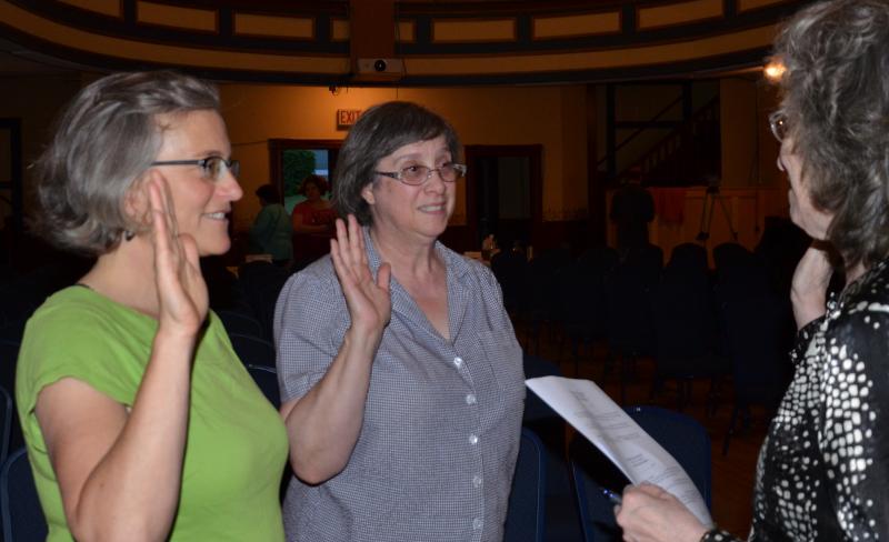 Eliza Haselton (Library Committee) and Helen Shaw (Budget Committee) get sworn in by Town Clerk Linda Greenlaw.