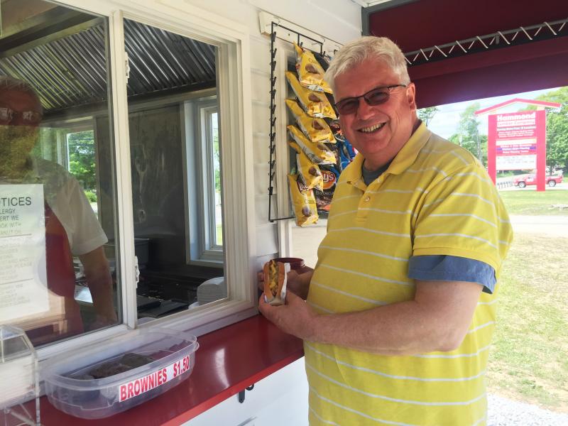 Jim Bickford of Westbrook stops by the new Wasses stand in Damariscotta for his first “one with everything.” SUZI THAYER/Boothbay Register
