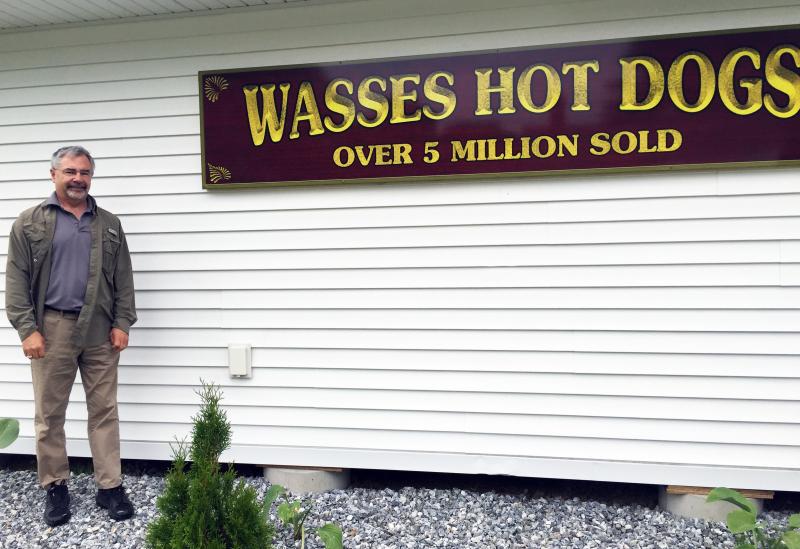 Keith Wass stands outside his new hot dog stand in Damariscotta, on the corner of Main Street and Biscay
Road. SUZI THAYER/Boothbay Register