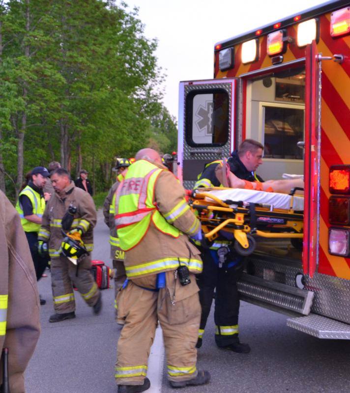Rescue crews lift the injured into the ambulance. (Photo by Lynda Clancy)