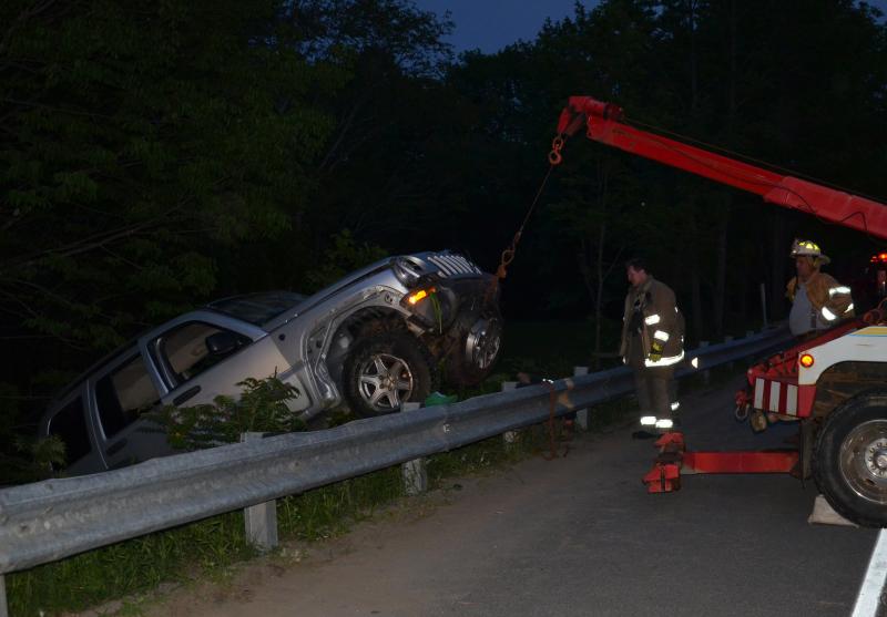 Steve and Jackie Laite bring the Jeep over over the embankment. (Photo by Lynda Clancy)