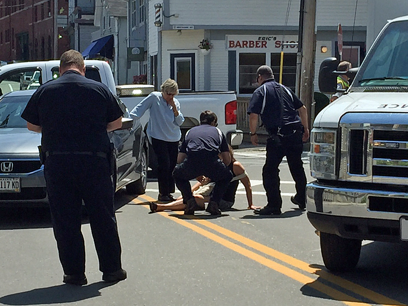 A North East Mobile Health Services crew assists Robin Pietila of Scarborough after she was hit by a car while she was walking in a crosswalk Monday around noon. (Photo by Holly S. Edwards)