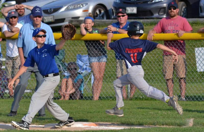 Draedyn Furrow, right, beats the throw to first with his quick speed. (Photo by George Harvey)