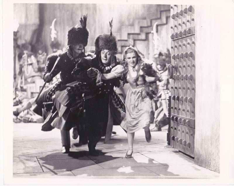 The first photo was taken in October 1938, when director Richard Thorpe began filming The Wizard of Oz at Metro-Goldwyn-Mayer's Culver City (California) studios. Judy Garland's Dorothy wore excessive make-up, a blonde wig, and plain, rhinestone ruby slippers with no bow. (Photo courtesy the collection of John Fricke)