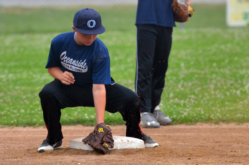 Shortstop Aidan Munro demonstrates the proper coverage of second base and applying the tag. (Photo by Ron Hawkes)