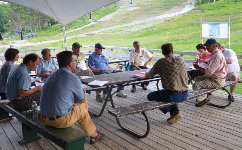 The Camden Select Board approved the Snow Bowl’s $947,464 budget July 13, on the deck at the Snow Bowl lodge. From left to right: Ragged Mountain Foundation board members Patrick Jones and Bob Gordon, Camden Town Manager Patricia Finnigan, Camden Select Board members Leonard Lookner, Don White and Martin Cates; Snow Bowl administration director Beth Ward; Select Board members John French and Jim Heard; and Snow Bow General Manager Landon Fake.