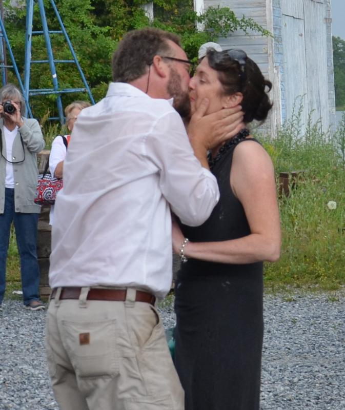 Noah Barnes gives his wife, Jane, a big kiss after she breaks a bottle of champagne on the bow of the Ladona. (Photo by Lynda Clancy)