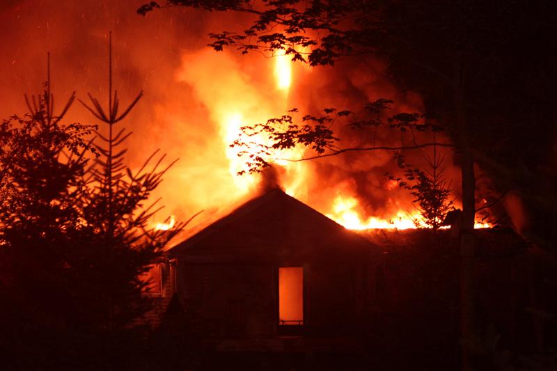 By the time firefighters were on scene and working the fire, it had consumed the residence, along with the attached garage, and could be seen burning through what had been the roof of the home. (Photo by Holly S. Edwards)