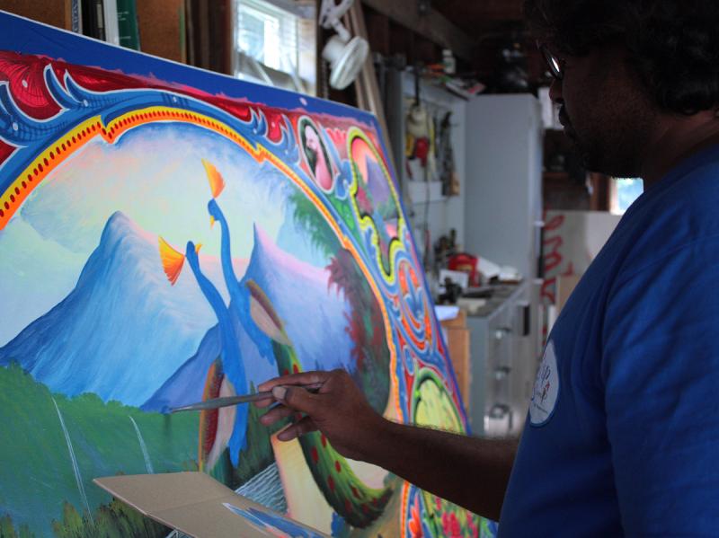 Haider Ali free hand paints the tiniest of details. (Photo by Holly S. Edwards)