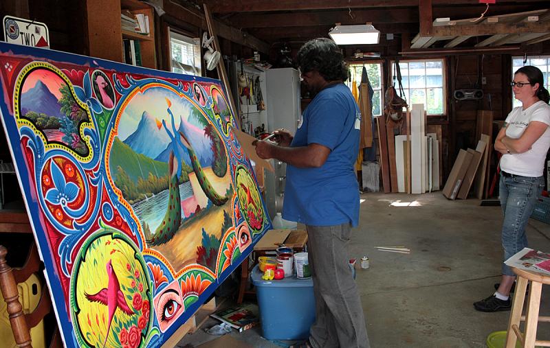 ‘I could stand here and watch him paint all day,’ said Kendra Denny of Rockland, Haider Ali’s friend, host and fellow artist. (Photo by Holly S. Edwards)