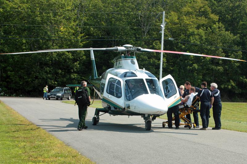 Kergan Thomann, 29, of Lincolnville, is loaded into a LifeFlight of Maine helicopter to be flown to Portland for treatment of burn injuries he sustained Sunday around noon at his home. (Photo by Holly S. Edwards)