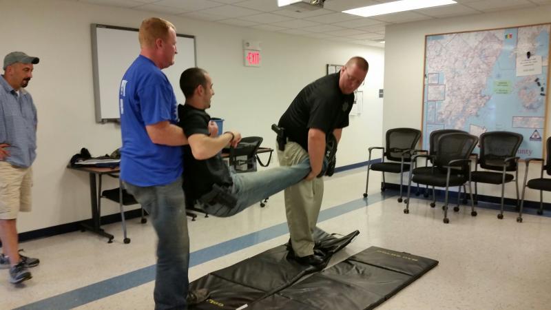 Deputy Jeremy Joslyn, role playing as an injured officer, is transported by Sgt. Ken Smith during a training exercise. (Photo by Sarah Shepherd)
