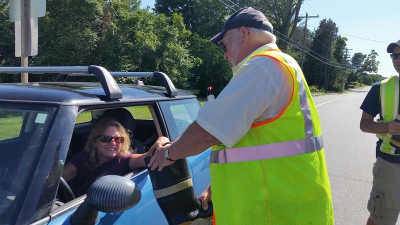 Firefighter Allen Mitchell is filling his boot with donations on Route 90. (Photo by Sarah Shepherd)