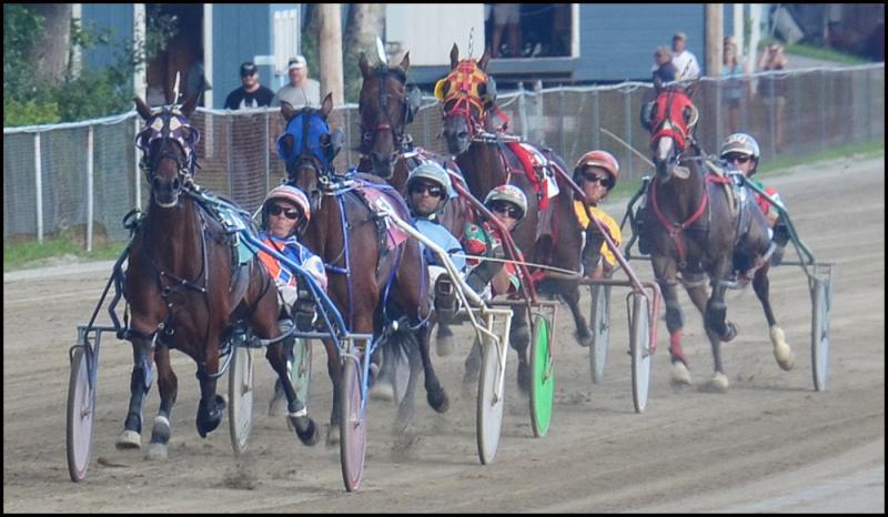 Horses race around the oval at the Union Fair Grounds on Thursday as their jockeys watch for their chance to get ahead. (Photos by Chris Wolf)